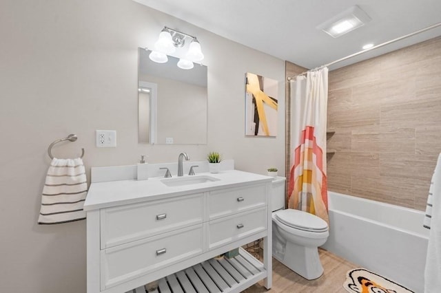 full bathroom with vanity, toilet, wood-type flooring, and shower / tub combo