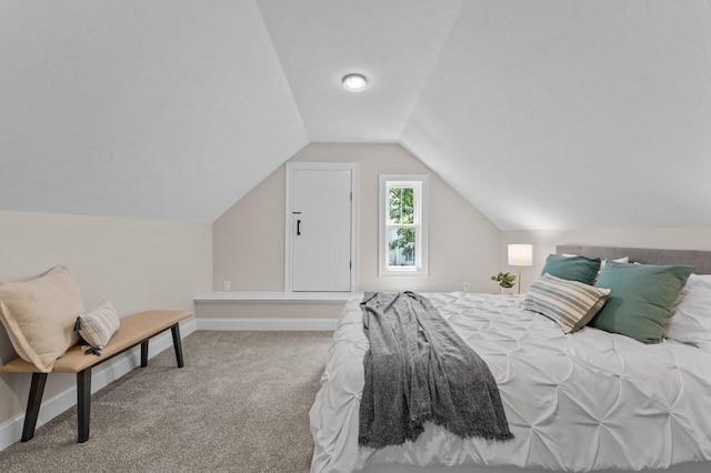 bedroom with carpet floors and vaulted ceiling