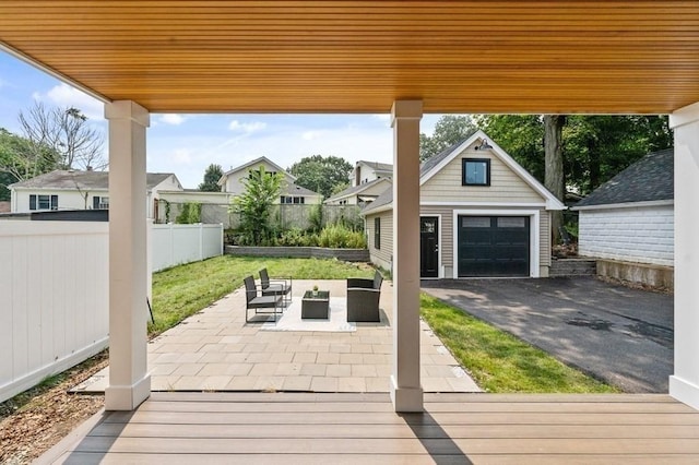 view of patio / terrace featuring outdoor lounge area, a garage, and an outdoor structure