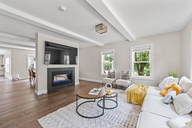 living room with beamed ceiling and dark wood-type flooring