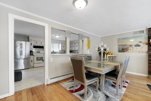 dining room featuring light hardwood / wood-style flooring, ornamental molding, and baseboard heating