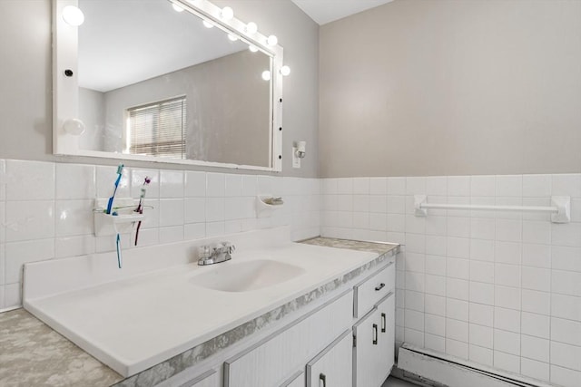 bathroom featuring vanity, a baseboard heating unit, and tile walls