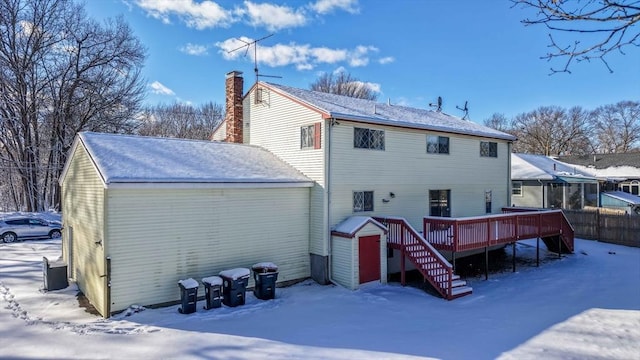 snow covered property with a deck