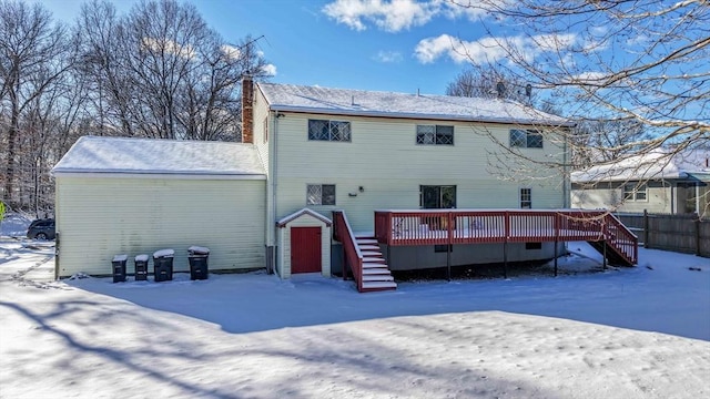 snow covered property featuring a deck