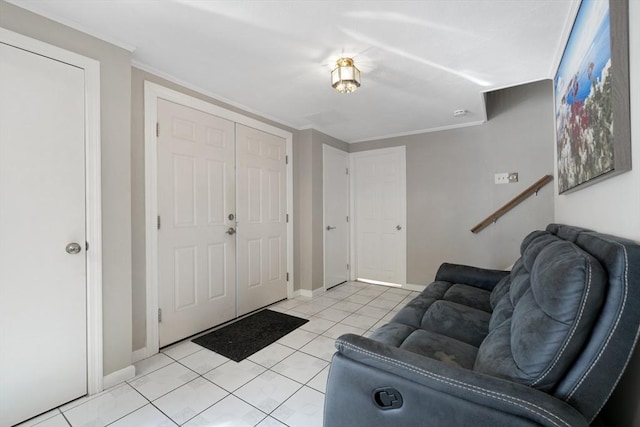 foyer entrance featuring ornamental molding and light tile patterned floors