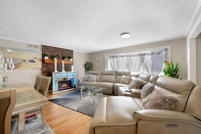 living room with hardwood / wood-style flooring and a large fireplace