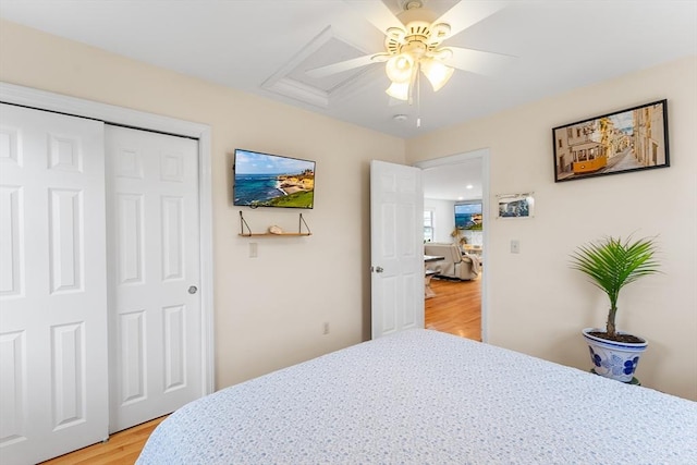 bedroom with a closet, ceiling fan, and light hardwood / wood-style flooring