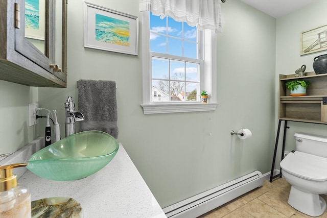 bathroom featuring sink, tile patterned flooring, a baseboard radiator, and toilet