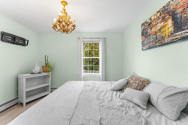 bedroom featuring baseboard heating, wood-type flooring, and an inviting chandelier