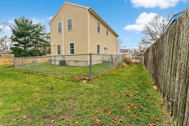 view of side of property with a lawn