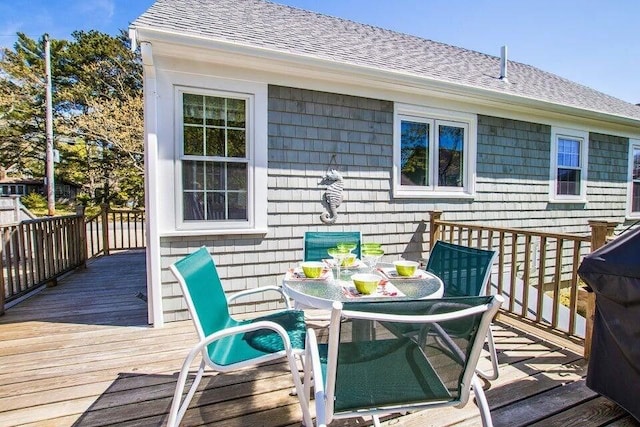 wooden deck with outdoor dining space