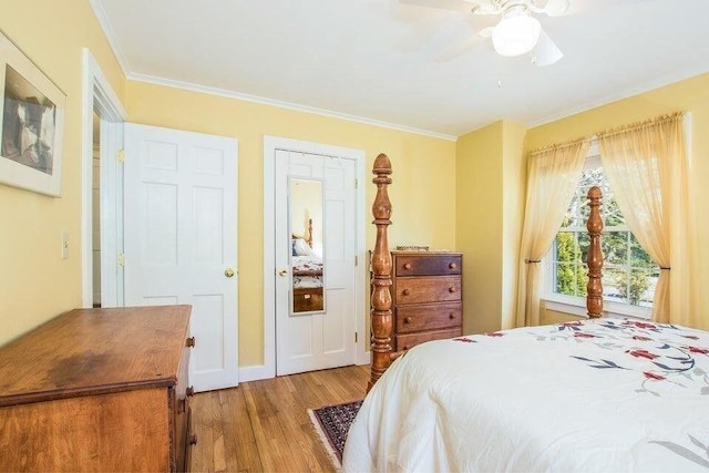 bedroom featuring ceiling fan, light wood-type flooring, and ornamental molding