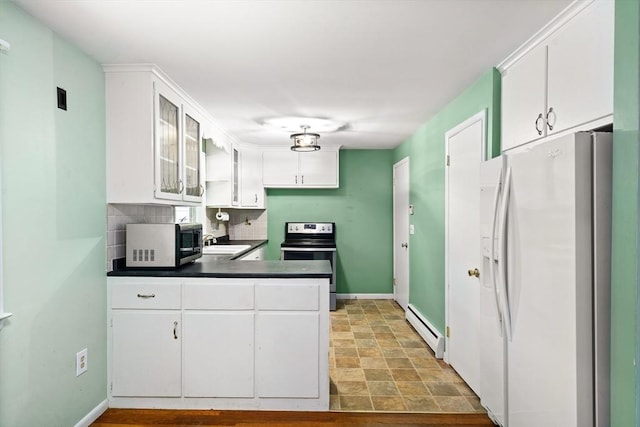 8 Grandview St, South Hadley, MA 01075 - kitchen featuring white refrigerator with ice dispenser, stainless steel electric range oven, a baseboard heating unit, dark countertops, and white cabinetry