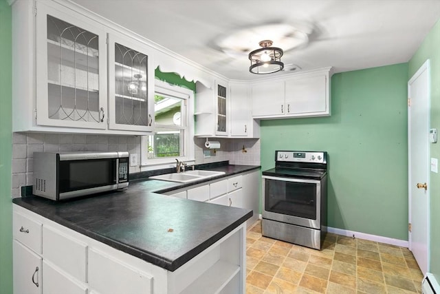 8 Grandview St, South Hadley, MA 01075 - kitchen with stainless steel appliances, open shelves, dark countertops, decorative backsplash, and white cabinetry