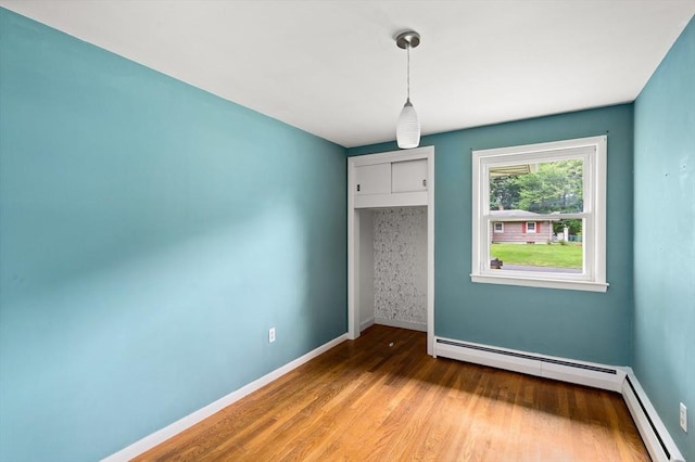 8 Grandview St, South Hadley, MA 01075 - unfurnished dining area with wood finished floors and a baseboard heating unit