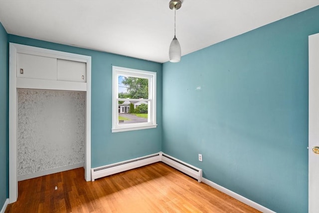8 Grandview St, South Hadley, MA 01075 - unfurnished bedroom with wood finished floors and a baseboard heating unit