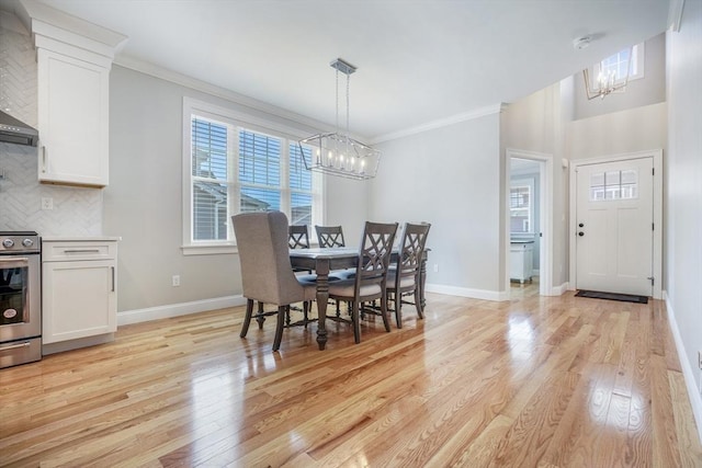 57 Sophia Dr, Rehoboth, MA 02769 - dining room with a chandelier, light wood-style flooring, and a healthy amount of sunlight