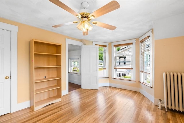 112 Lawrence St, Fitchburg, MA 01420 - unfurnished bedroom with radiator, light wood-type flooring, and baseboards