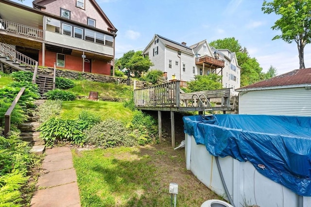 112 Lawrence St, Fitchburg, MA 01420 - view of yard with stairway, a deck, and a covered pool