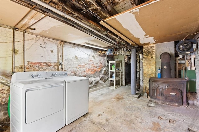112 Lawrence St, Fitchburg, MA 01420 - unfinished below grade area featuring washer and dryer and a wood stove