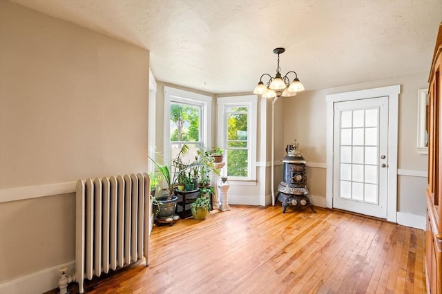 112 Lawrence St, Fitchburg, MA 01420 - dining space featuring radiator, a chandelier, hardwood / wood-style flooring, and baseboards