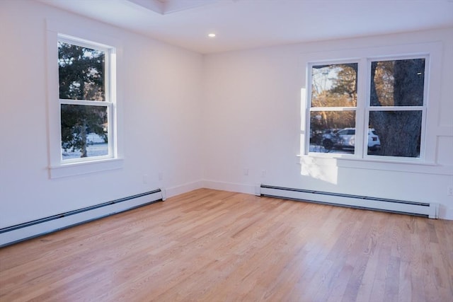 empty room with a baseboard radiator and light wood-type flooring