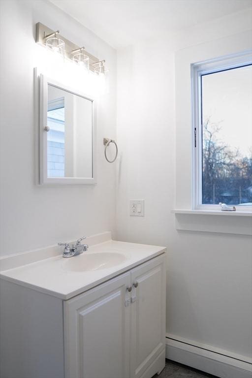 bathroom featuring vanity and baseboard heating