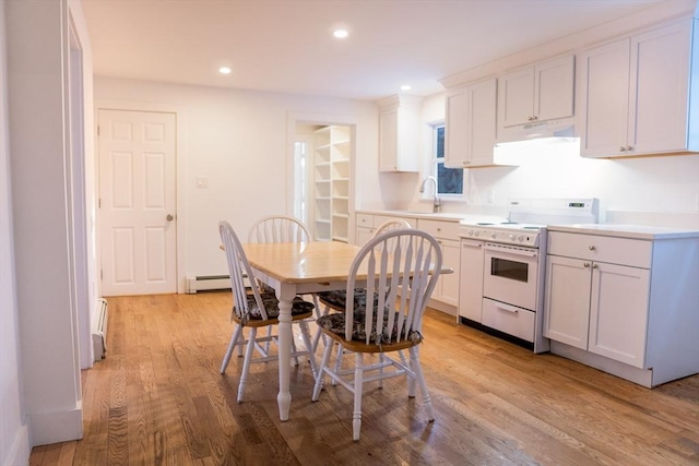 kitchen featuring light hardwood / wood-style flooring, white electric stove, and white cabinets