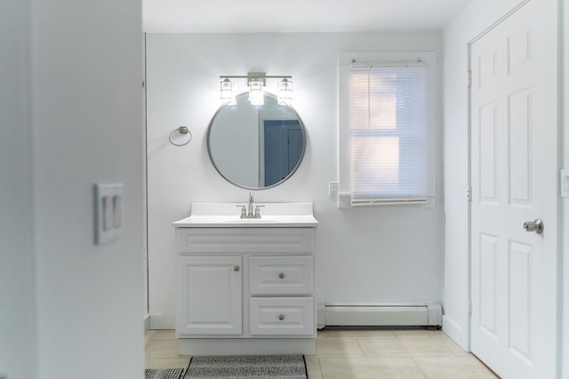 bathroom featuring tile patterned flooring, vanity, and a baseboard heating unit