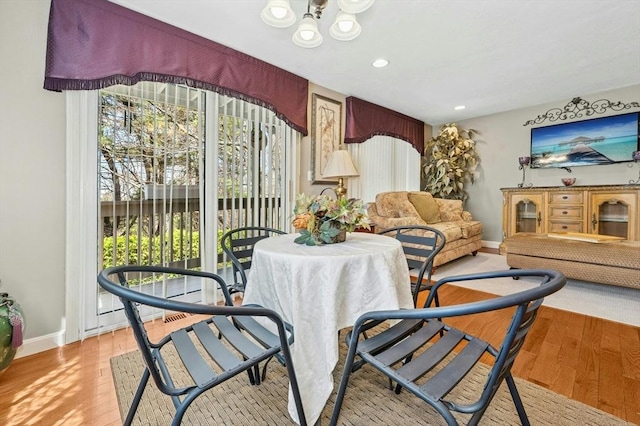 living room featuring baseboards, a wealth of natural light, and light wood-style floors