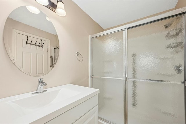 bathroom featuring vanity and a shower stall