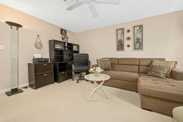 living area with a ceiling fan, light colored carpet, and baseboards