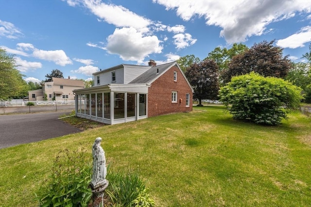 405 Granby Rd, South Hadley, MA 01075 - view of side of property featuring a sunroom, a chimney, and brick siding