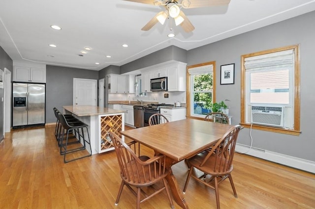 dining area with a ceiling fan, recessed lighting, cooling unit, light wood finished floors, and baseboards