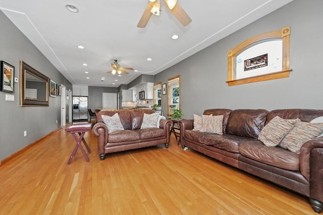 living area with recessed lighting, light wood-style flooring, baseboards, and ceiling fan