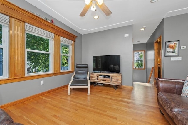 living area featuring recessed lighting, a ceiling fan, baseboards, and wood finished floors