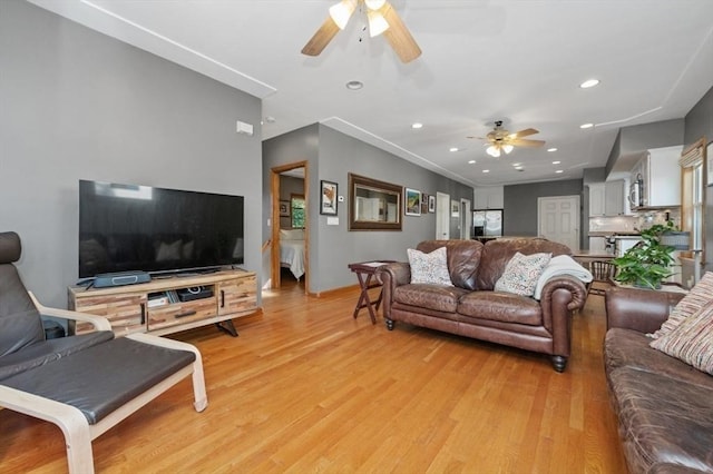 living room featuring recessed lighting, light wood-style flooring, baseboards, and a ceiling fan