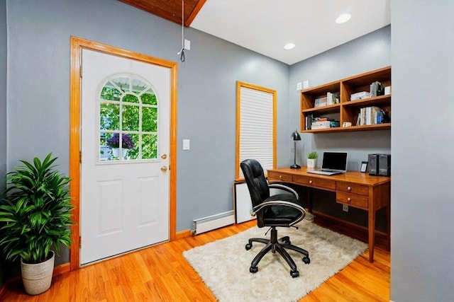 office featuring recessed lighting, light wood-type flooring, baseboard heating, and baseboards