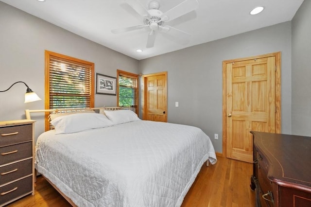 bedroom with a ceiling fan, recessed lighting, light wood-type flooring, and baseboards