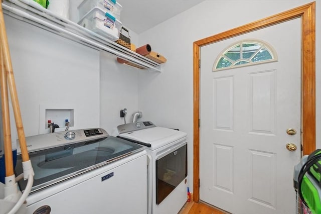 clothes washing area with laundry area and washer and clothes dryer