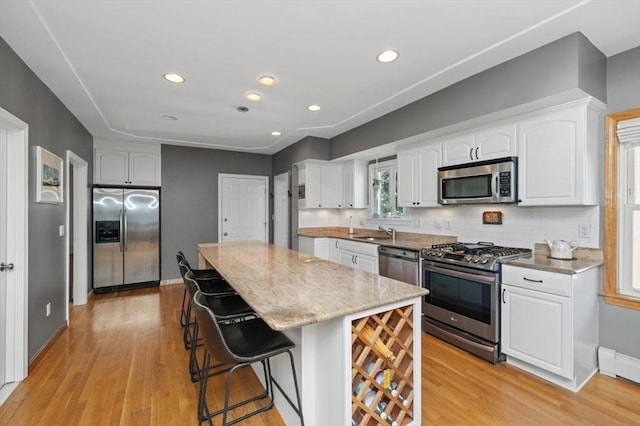 kitchen featuring white cabinets, appliances with stainless steel finishes, and a sink