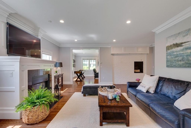 122 Crescent Rd, Concord, MA 01742 - living room featuring a fireplace, wood finished floors, recessed lighting, and crown molding