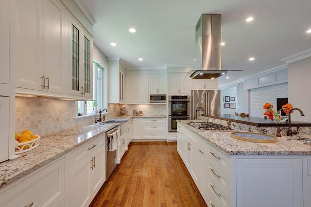 122 Crescent Rd, Concord, MA 01742 - kitchen with stainless steel appliances, white cabinets, light stone countertops, glass insert cabinets, and light wood-style flooring