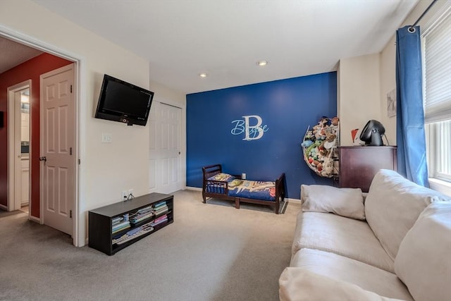carpeted living area with baseboards and recessed lighting
