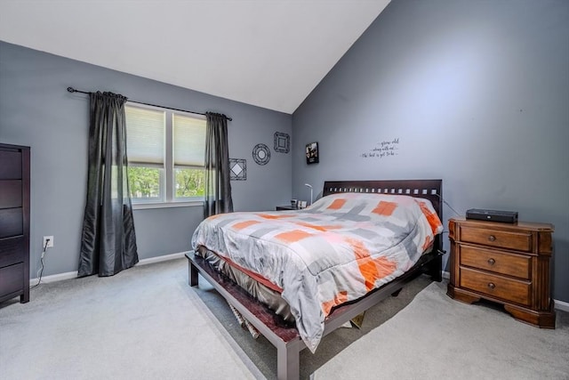 bedroom featuring light carpet, baseboards, and high vaulted ceiling