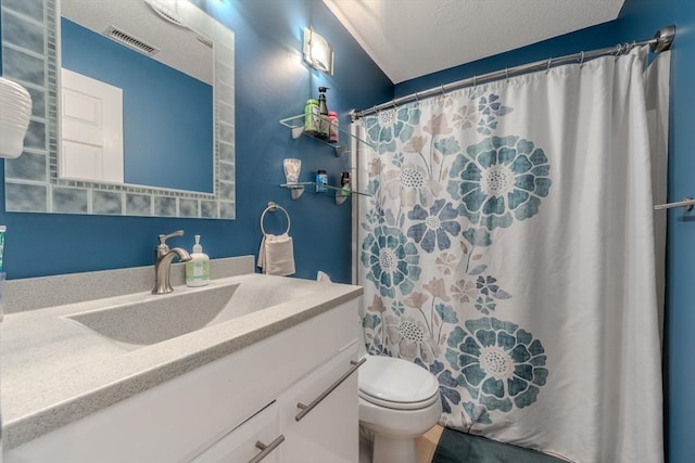 full bath featuring vanity, toilet, a textured ceiling, and a shower with shower curtain