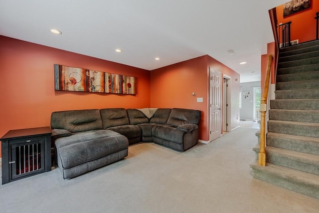 carpeted living area with stairs, recessed lighting, and baseboards