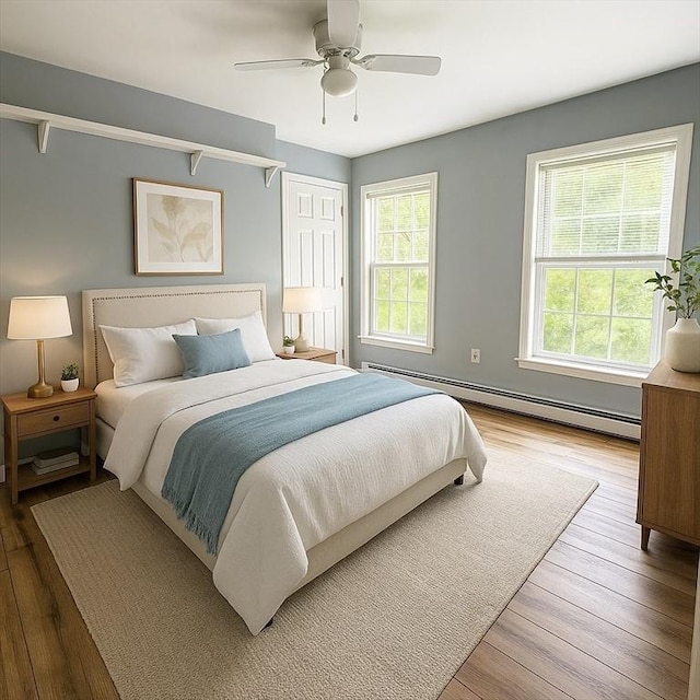 6 Debbie Ln, Freetown, MA 02702 - bedroom featuring a baseboard heating unit, wood finished floors, and ceiling fan