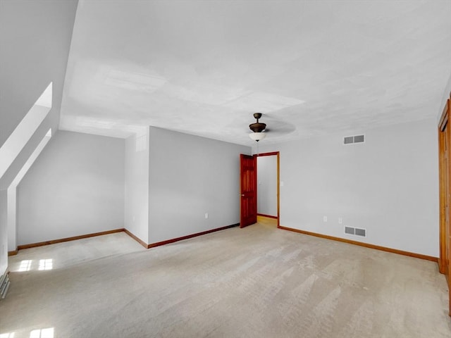 bonus room featuring light colored carpet and ceiling fan