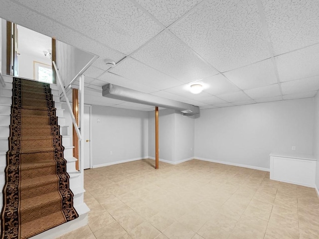 basement featuring a paneled ceiling